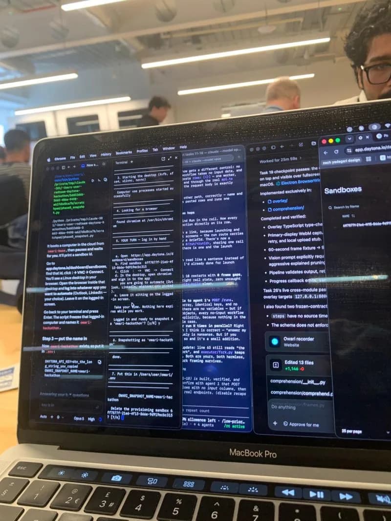 A MacBook covered in terminal and agent windows, with the Daytona sandboxes dashboard open on the right, in a busy room